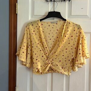Yellow, flowery, crop top with flowy short sleeves. Size large.